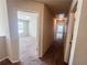Bright hallway featuring neutral walls, carpeted floors, and open doorways into bedrooms, offering a welcoming transition between rooms at 1291 Vienna Ct, Hampton, GA 30228
