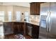 Kitchen island features granite countertops, stainless steel appliances, and dark cabinetry at 1291 Vienna Ct, Hampton, GA 30228