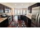 Open-concept kitchen with stainless steel appliances, dark cabinets, and granite countertops at 1291 Vienna Ct, Hampton, GA 30228