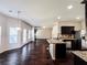 Open-concept kitchen with stainless steel appliances, dark cabinets, and granite countertops at 1291 Vienna Ct, Hampton, GA 30228