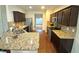 Kitchen with granite countertops, stainless steel appliances, and wooden cabinets at 1291 Vienna Ct, Hampton, GA 30228