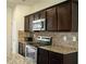 Close-up of the kitchen featuring stainless steel appliances, granite countertops, and stylish cabinetry at 1291 Vienna Ct, Hampton, GA 30228