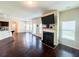 Open-concept living room with fireplace, hardwood floors, and modern kitchen at 1291 Vienna Ct, Hampton, GA 30228