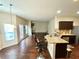 Open-concept living room and kitchen with granite countertops and stainless steel appliances at 1291 Vienna Ct, Hampton, GA 30228