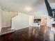 Open-concept living room with hardwood floors and view into the kitchen at 1291 Vienna Ct, Hampton, GA 30228