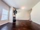 Bright living room featuring a fireplace, hardwood floors, and staircase at 1291 Vienna Ct, Hampton, GA 30228