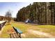 Community playground featuring slides, climbing structures, and swings with a relaxing bench at 1291 Vienna Ct, Hampton, GA 30228
