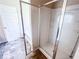 A modern bathroom features a glass-enclosed shower with built-in shelves at 1291 Vienna Ct, Hampton, GA 30228