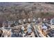 An aerial view of a residential neighborhood shows many homes and tree coverage at 230 Society St, Alpharetta, GA 30022