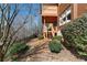 Backyard view shows a deck with stairs leading down to the yard and a wooded area beyond at 230 Society St, Alpharetta, GA 30022