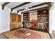 Elegant bar area with wood beams, built-in shelving, and wine storage at 230 Society St, Alpharetta, GA 30022