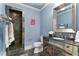 Charming bathroom with blue walls, tile shower, and decorative vanity at 230 Society St, Alpharetta, GA 30022