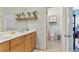 Bathroom with double sinks, wood cabinetry, and a view into the toilet room at 230 Society St, Alpharetta, GA 30022