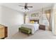 Bedroom featuring neutral walls, wooden accents, and a large ceiling fan at 230 Society St, Alpharetta, GA 30022