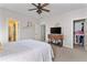Bedroom featuring neutral walls, wooden furniture, and view into the walk-in closet at 230 Society St, Alpharetta, GA 30022