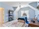 Bedroom with vaulted ceiling, decorative rug, shelving, and a work desk at 230 Society St, Alpharetta, GA 30022