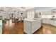 Bright, open-concept kitchen featuring white cabinetry, a center island, and stainless steel appliances at 230 Society St, Alpharetta, GA 30022