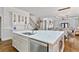 Spacious kitchen island with white countertops, stainless steel appliances, and open layout to the dining area at 230 Society St, Alpharetta, GA 30022