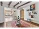 Inviting living room featuring a large window seat, stone archway, and open layout at 230 Society St, Alpharetta, GA 30022