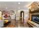 Spacious living room featuring a stone fireplace, arched doorway, and unique floor design at 230 Society St, Alpharetta, GA 30022