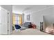Bright living room featuring a gray sofa, blue chair, and colorful artwork at 230 Society St, Alpharetta, GA 30022