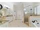 Elegant main bathroom with a double vanity, soaking tub, and glass-enclosed shower at 230 Society St, Alpharetta, GA 30022