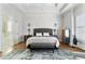 Bright main bedroom featuring hardwood floors, large windows, and a decorative rug at 230 Society St, Alpharetta, GA 30022
