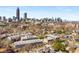 Overhead view of brick apartment buildings nestled amongst trees, showcasing the Atlanta skyline in the background at 384 Ralph Mcgill Ne Blvd # 314, Atlanta, GA 30312