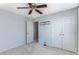 Bedroom featuring ceiling fan, neutral carpet, large closet, and light blue wall paint at 620 Dahoma Trl, Woodstock, GA 30188