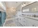 Bright bathroom featuring double vanity, patterned tile floor, and separate tub and shower at 1591 Alder Se Ct, Atlanta, GA 30317