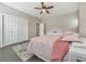 Comfortable bedroom with gray wood floors, ceiling fan, and closet with bi-fold doors at 1591 Alder Se Ct, Atlanta, GA 30317