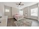 Inviting bedroom with a ceiling fan, two windows, and a decorative rug at 1591 Alder Se Ct, Atlanta, GA 30317