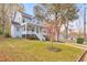 Two-story home with covered front porch, mature tree, and lush green lawn at 1591 Alder Se Ct, Atlanta, GA 30317