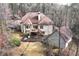 Aerial view of the house highlighting the deck, stairs, and surrounding landscape at 2557 Sixes Rd, Canton, GA 30114