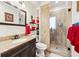 Bright bathroom with a glass-enclosed shower, granite countertop vanity, and built-in shelving for ample storage at 2557 Sixes Rd, Canton, GA 30114