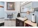 Bathroom vanity with granite countertop, patterned tile backsplash, and soft blue walls at 2557 Sixes Rd, Canton, GA 30114