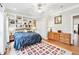 Bright bedroom with a large bed, built-in shelves, hardwood floors, and a neutral-toned area rug at 2557 Sixes Rd, Canton, GA 30114