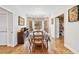 Bright dining room featuring hardwood floors, natural light, and a view to the backyard at 2557 Sixes Rd, Canton, GA 30114