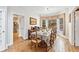 Bright dining room boasts hardwood floors, and wainscoting around large bay window overlooking backyard at 2557 Sixes Rd, Canton, GA 30114