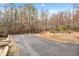 Long gravel driveway with ample space for parking at 2557 Sixes Rd, Canton, GA 30114