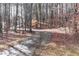 Winding driveway is shaded by the woods in the foreground at 2557 Sixes Rd, Canton, GA 30114