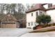 Spacious home with a stone and stucco exterior, featuring a multi-car garage and ample parking space at 2557 Sixes Rd, Canton, GA 30114