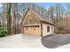 Spacious garage featuring stone accents and a matching exterior at 2557 Sixes Rd, Canton, GA 30114