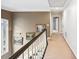 Well-lit hallway with elegant trim details provides access to various rooms in the home at 2557 Sixes Rd, Canton, GA 30114