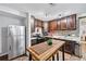 Well-lit kitchen featuring stainless steel appliances and an island with seating for casual dining at 2557 Sixes Rd, Canton, GA 30114