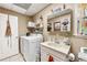 Functional laundry room features washer, dryer, sink, and storage shelves for convenience at 2557 Sixes Rd, Canton, GA 30114