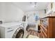 Laundry room with a front load washer and dryer, and wood-look flooring at 2557 Sixes Rd, Canton, GA 30114