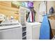 Functional laundry room with a washer, dryer, shelving, an ironing board, and space-saving organization solutions at 2557 Sixes Rd, Canton, GA 30114