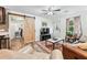 Living room featuring a leather sofa, natural light, wood flooring, and barn door access at 2557 Sixes Rd, Canton, GA 30114