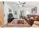 Cozy living room features a ceiling fan, comfortable leather seating, and a stylish accent rug at 2557 Sixes Rd, Canton, GA 30114